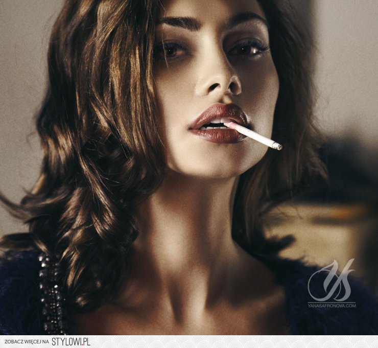 Brunette smoking cigar the stairs